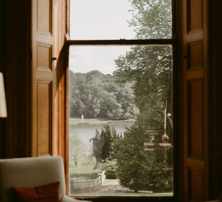 View of Castle Leslie grounds through the window in wood panelled room