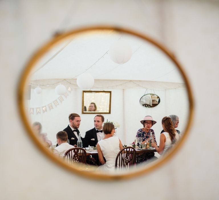 Photography through mirror of wedding party during reception