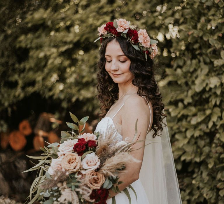 Boho ASOS wedding dress bride with long wavy hair in a red and pink flower crown 