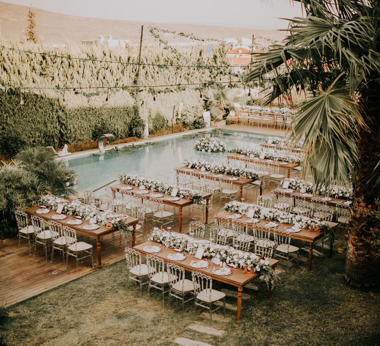 Outdoor Turkish wedding ceremony with white florals and banquet tables for 120 guests