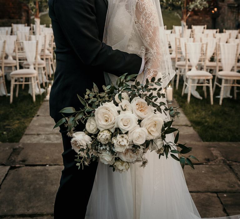 Groom kissing his brides forehead at the bombed out church in Liverpool 