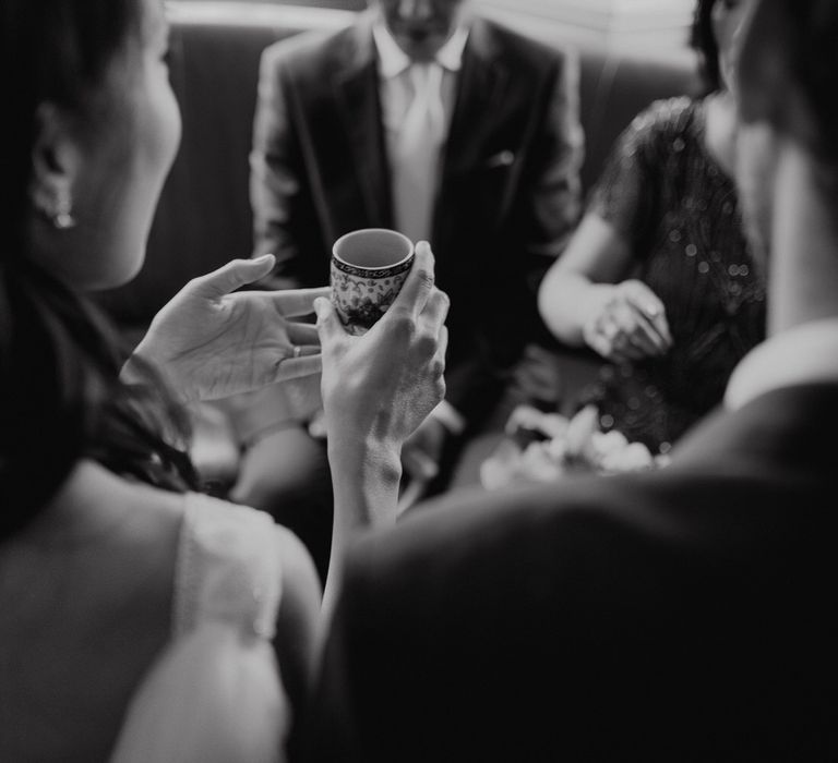 Bride holding the drinking cup at Chinese tea ceremony