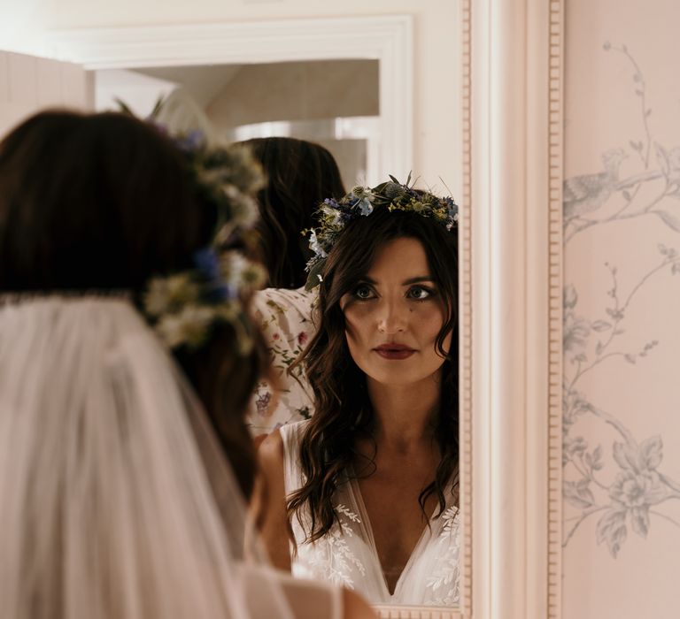 Bride looks in the mirror on the day of her wedding