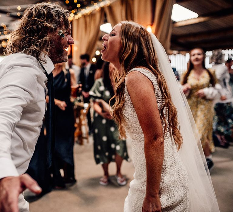 Bride and groom dance in barn venue