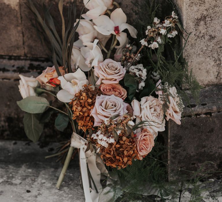 Dried and fresh flower wedding bouquet with muted roses, hydrangeas and orchids 