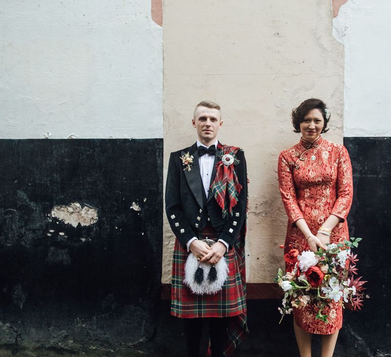 Bride and groom in traditional outfits for multicultural wedding