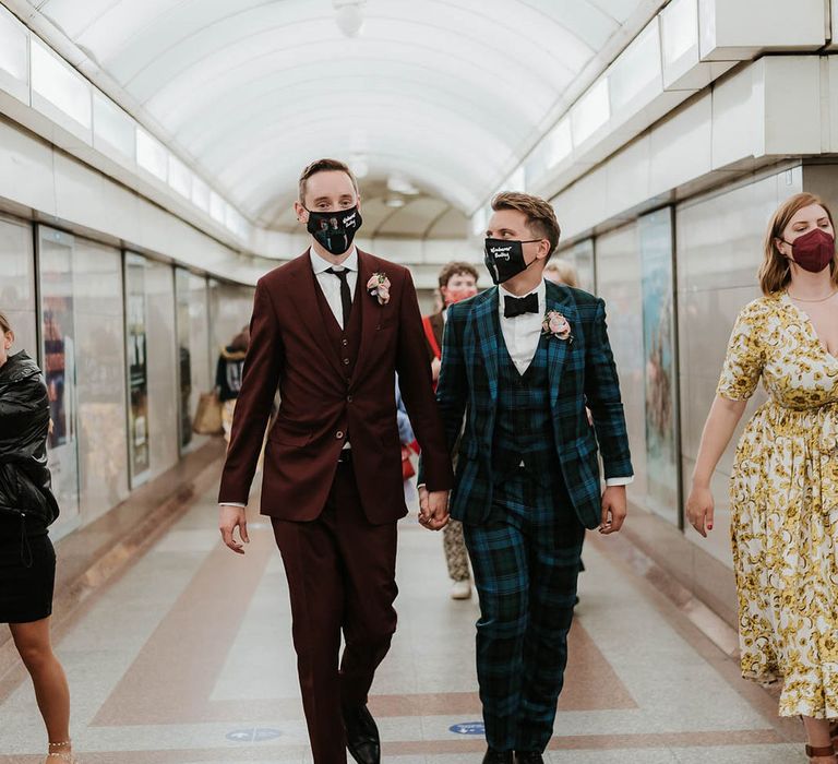 Grooms walk through tube station whilst wearing face masks as they make their way to wedding reception | Kim Williams Weddings