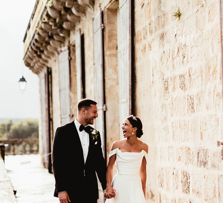 Bride & groom walk hand in hand on their wedding day