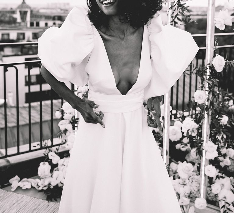 South Asian bride in a puff sleeve wedding dress with plunging neckline at stylish Paris elopement 