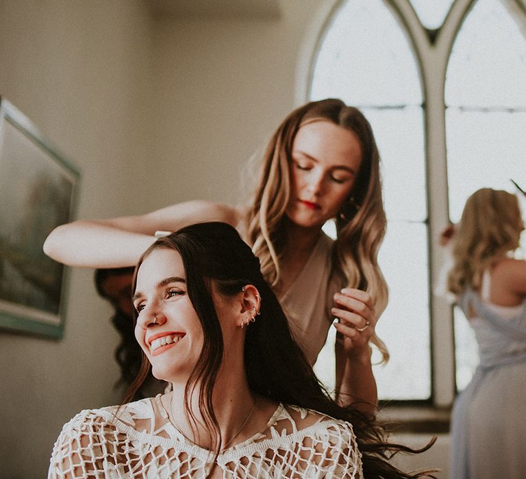 Bride has her hair done on the morning of her wedding day