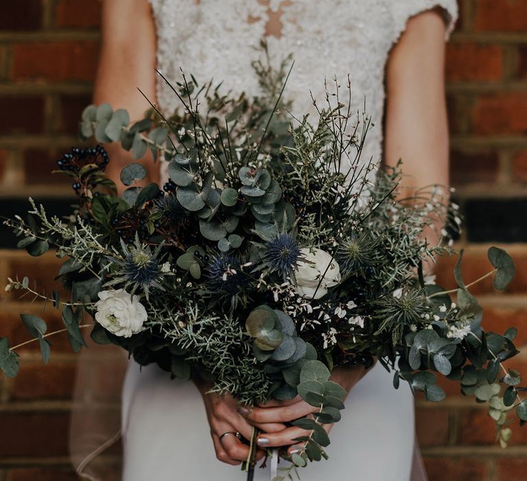 Brides floral bouquet complete with green foliage and white flowers 