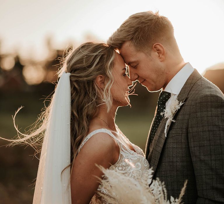 Bride and groom share a moment during golden hour