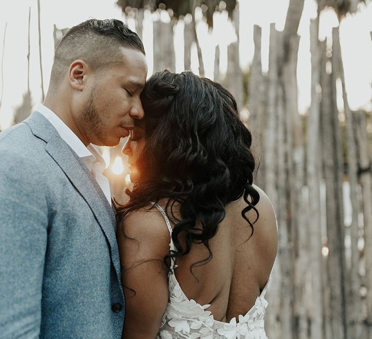 Bride and groom at their destination wedding in Mexico during golden hour as sun sets