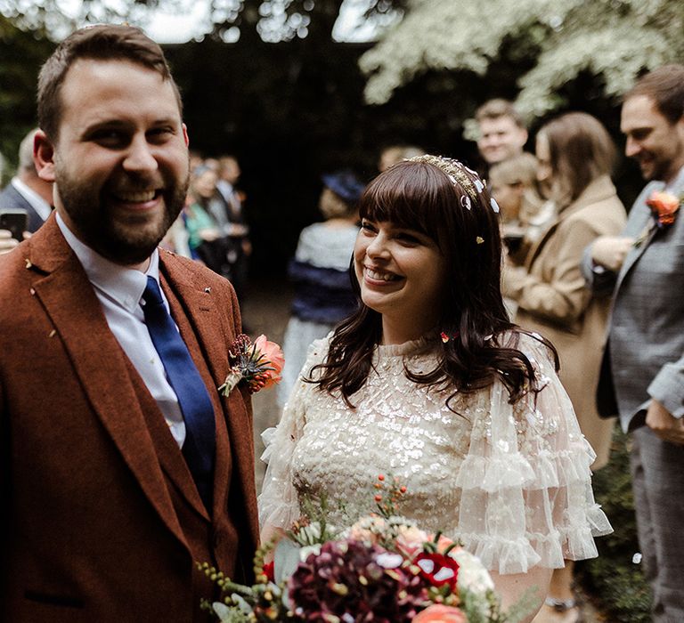 Smiling bride and groom after their confetti exit from their intimate ceremony 