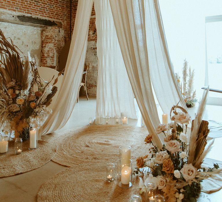 Dried flowers with wedding drapes for neutral decor boho wedding with candles and toffee and rust roses 