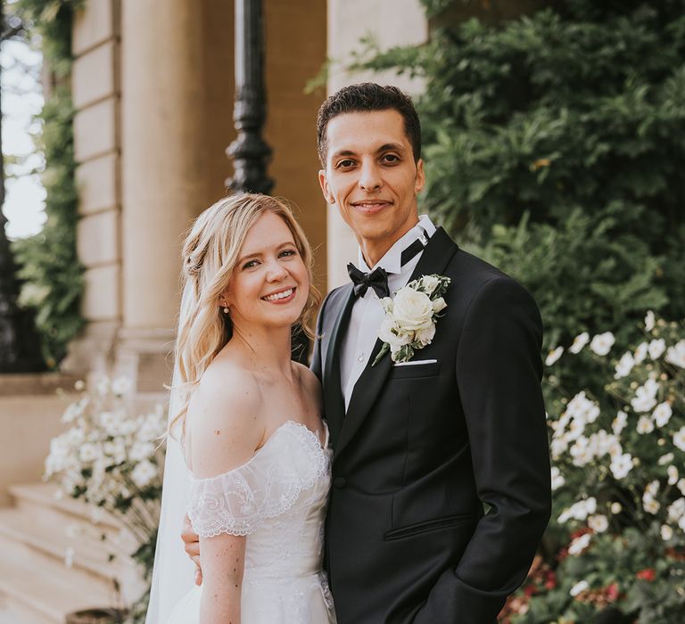 bride in ballgown wedding dress posing with groom in black tie for classic wedding 