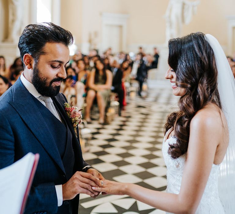 Bride & groom exchange rings during wedding ceremony at Syon Park