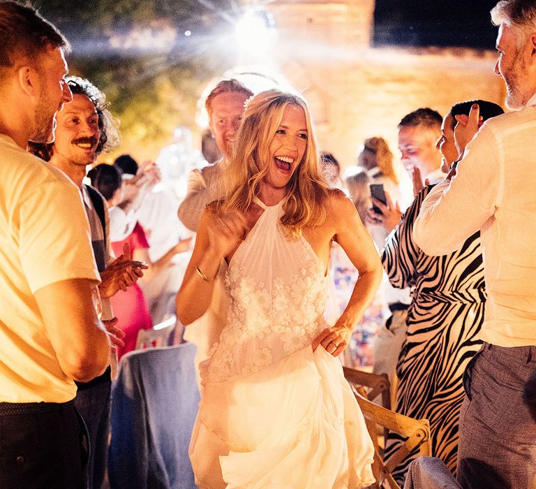 Bride and groom dance down the aisle between the banquet wedding tables 