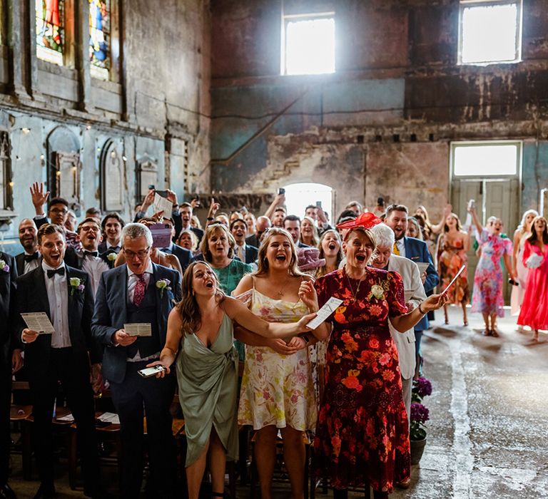 Wedding guests sing at The Asylum during ceremony 