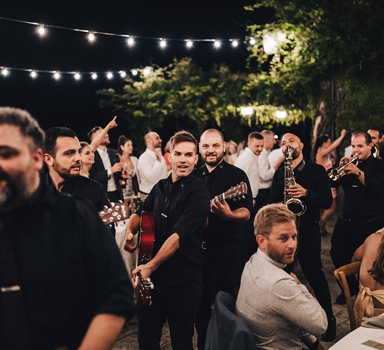 Wedding band plays during outdoor Italian wedding reception