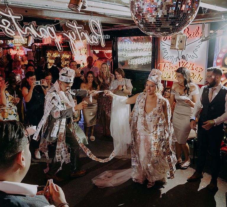 Bride and groom doing Greek Money Dance at London wedding 