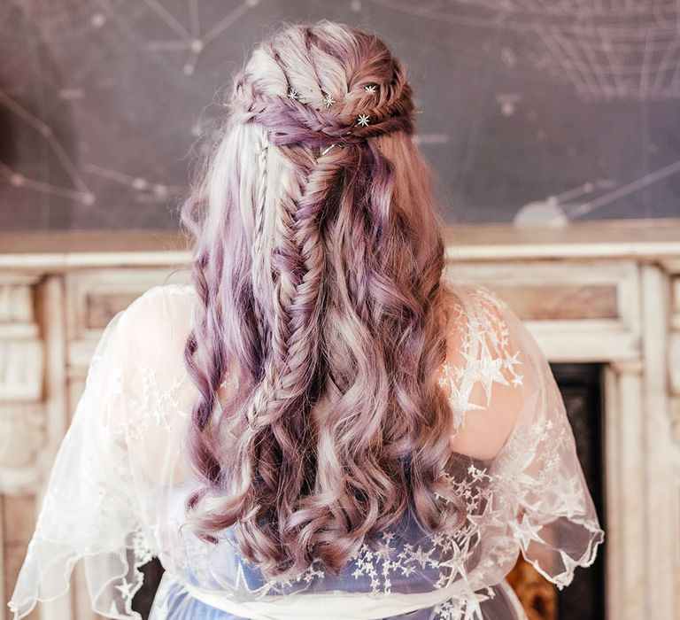 Bride's fishtail plait wedding hair and silver celestial star-shaped hair accessories, wearing sheer, celestial bridal robe with embroidered stars and short flowing sleeves 