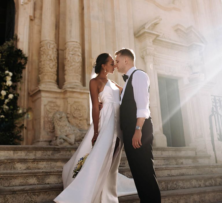 golden hour wedding photograph with bride in a one shoulder wedding dress