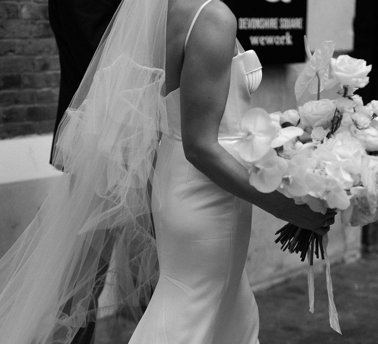 Bride in Alena Leena Bridal satin wedding dress and Bridal Boutique Warwickshire veil 