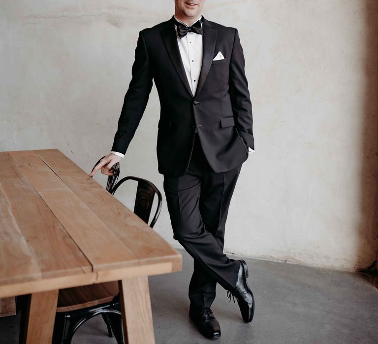 Groom in blaxk tuxedo and bow tie at Upton Barn wedding venue