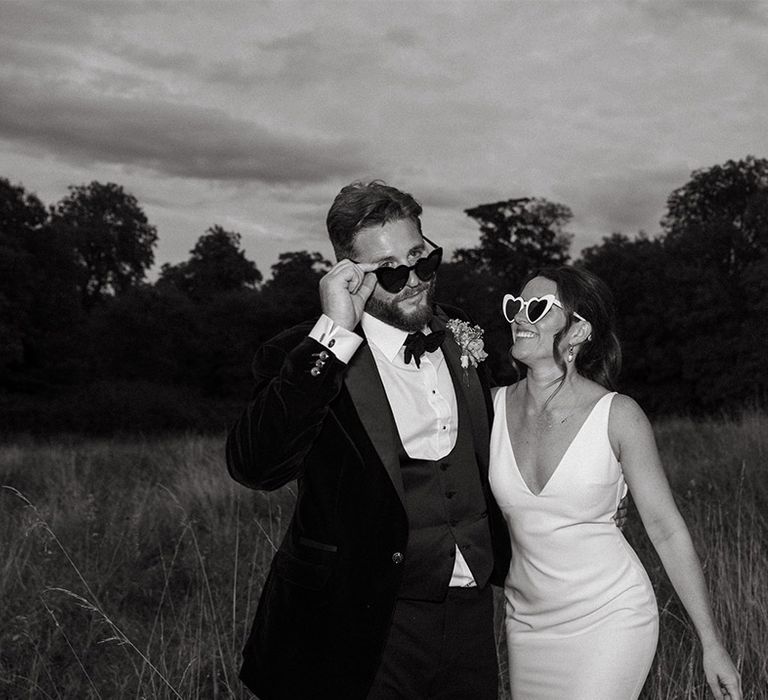 Bride and groom in stylish wedding sunglasses for couple photo 