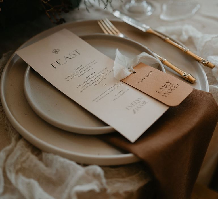 Elegant cream wedding menu with orange place name card at country house wedding 