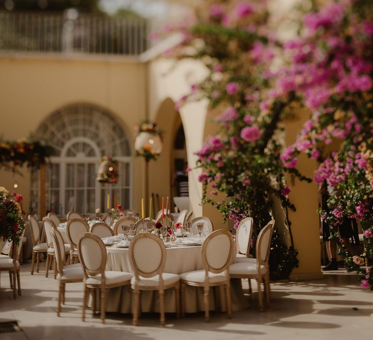 outdoor reception at Croatia wedding with round tables and bright wedding flowers