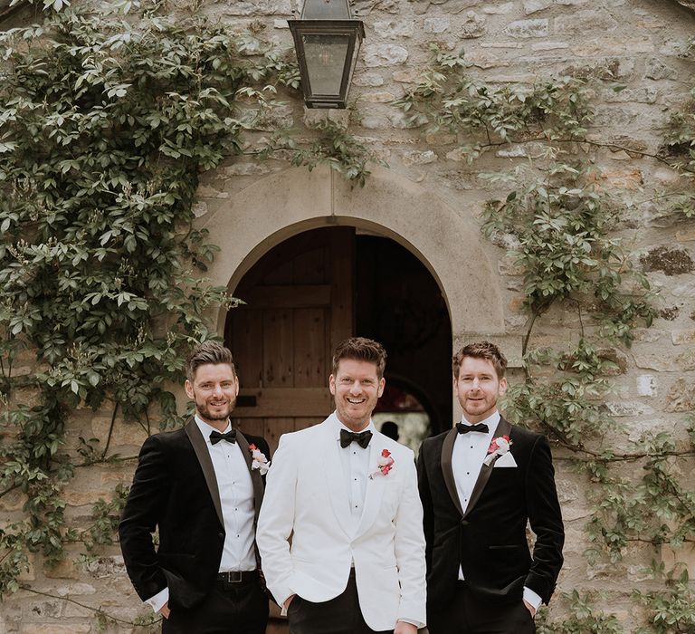 Groom and groomsmen in black and white wedding outfits for modern wedding 