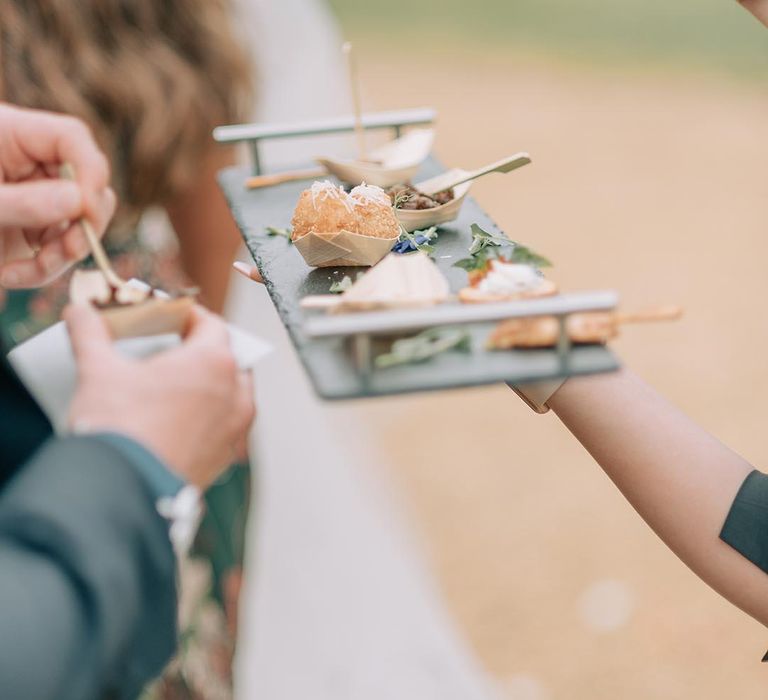 Sharing platter of canapés served for the wedding guests 