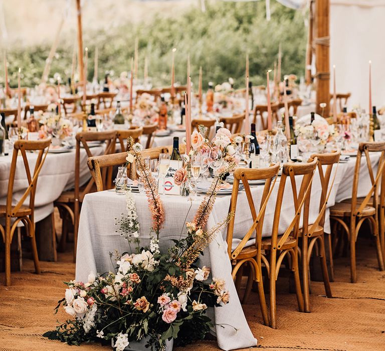 marquee Sennen Cove wedding reception with wicker lampshade and foliage hanging installation wedding flower arrangements 