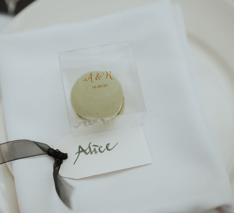 green macaroon wedding favour in a clear box 