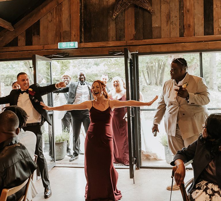 Wedding party dance their way into the wedding reception in fun entrance 