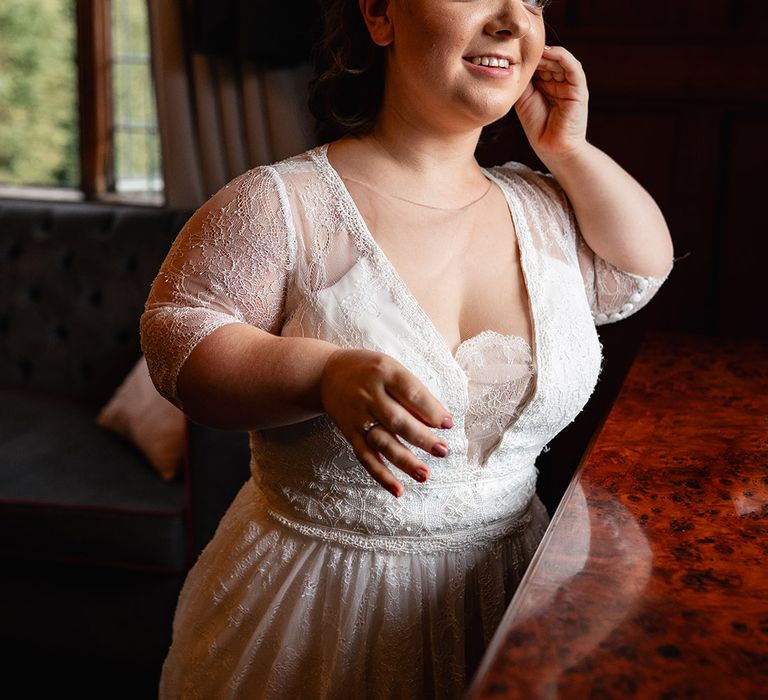 Bride wearing hair in an updo in lace wedding dress 