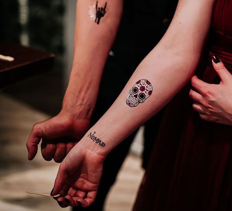 Image of people with temporary tattoos on their forearms at a wedding