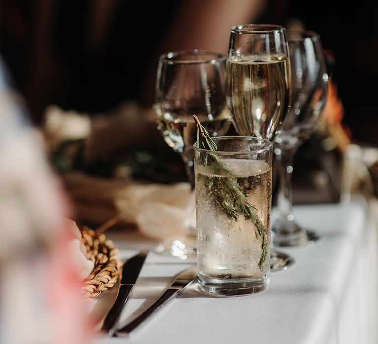 Glasses of wine and beverages for the wedding guests with garnishes 