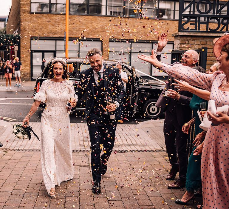 Epic confetti moment with dried petals for the wedding entrance to the reception for the bride and groom 