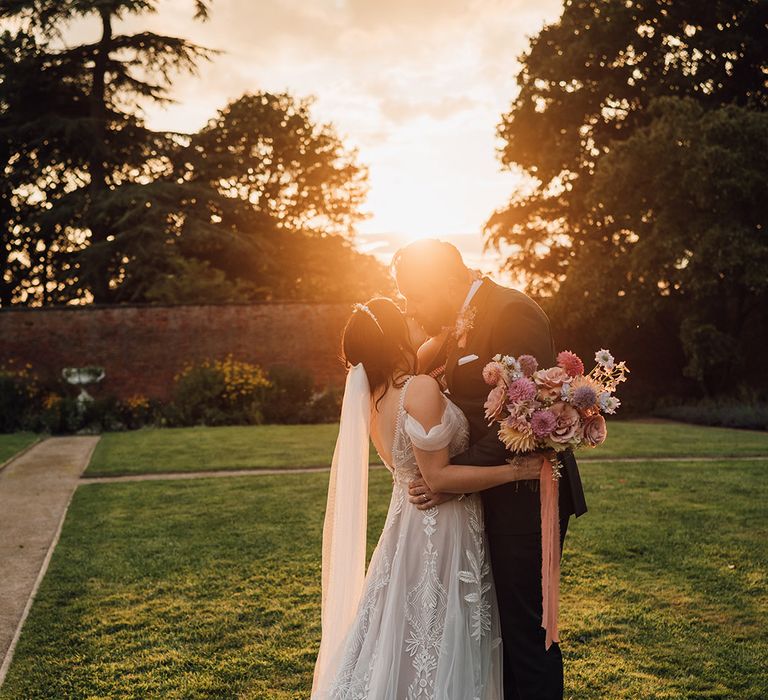 Golden hour glow of the couple sharing an embrace 