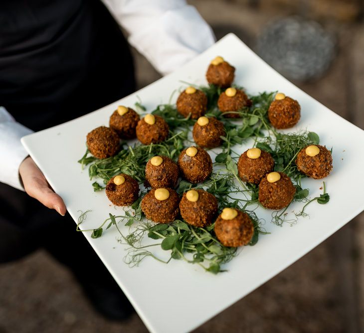 Canapés at London wedding with disco ball wedding decor