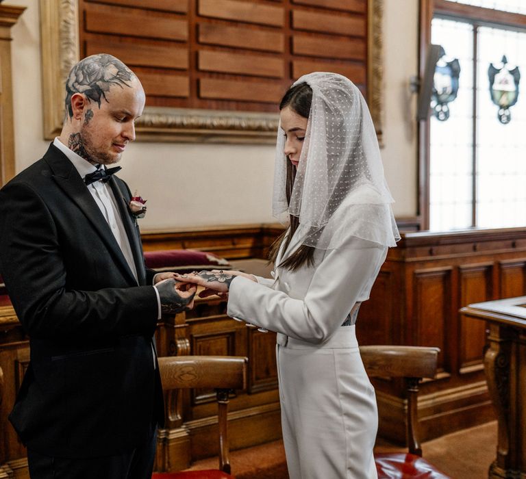 Bride and groom exchanging rings at Brighton wedding ceremony 