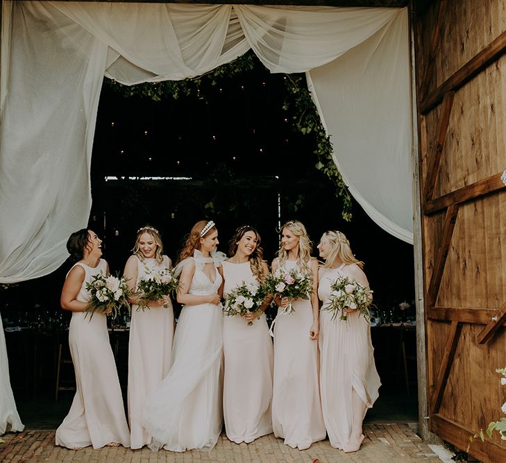 Bridal party portrait with bridesmaids in blush pink dresses 