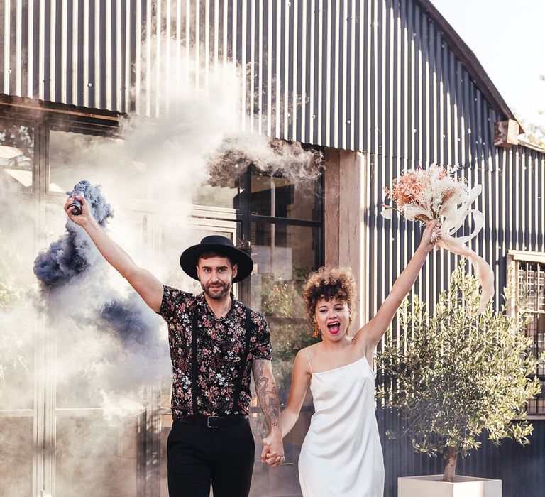 Bride and groom smoke bomb portrait with bride in leopard print boots 