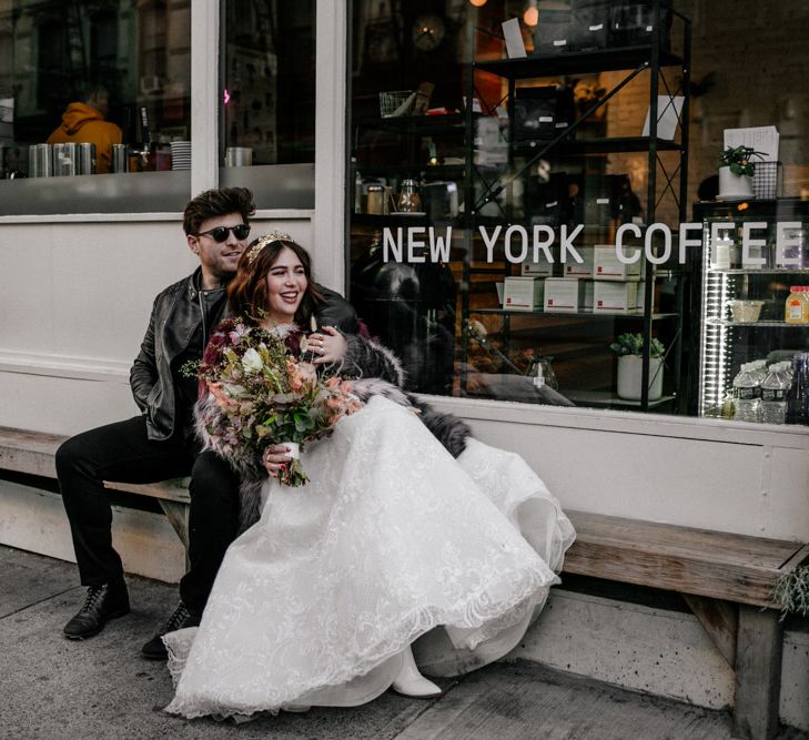 Bride & groom outside shop front 