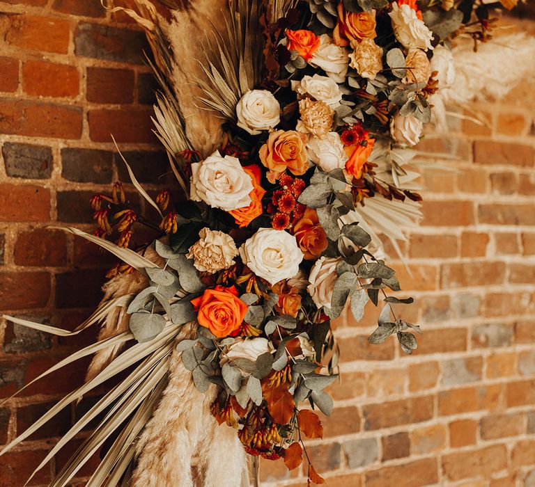 Close up shot of flower decor on hexagonal aisle structure