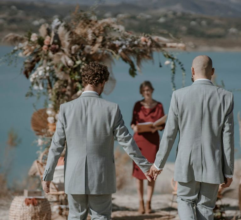 The grooms walking down the aisle at same-sex elopement ceremony