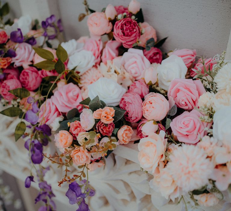 Floral bouquet featuring roses in differing hues of pink